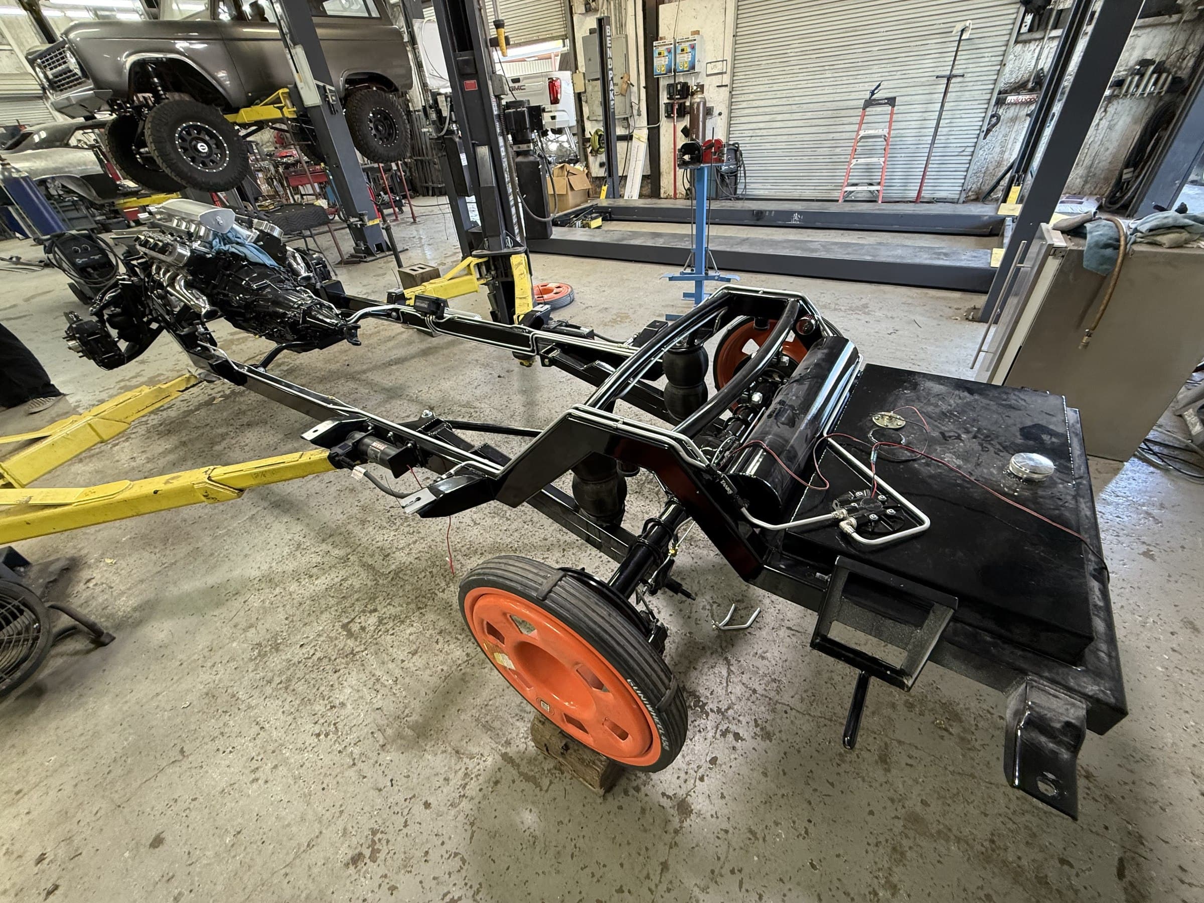 Custom tube chassis with air ride, big-block engine, and hand-built exhaust headers built by 2 Man Fab