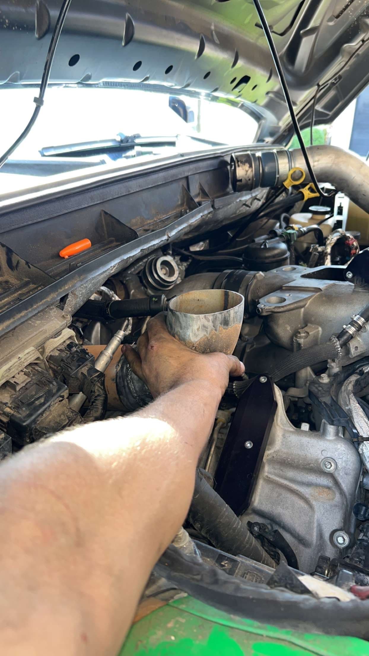 Hand-fitting a custom piping section during a motor swap at 2 Man Fab