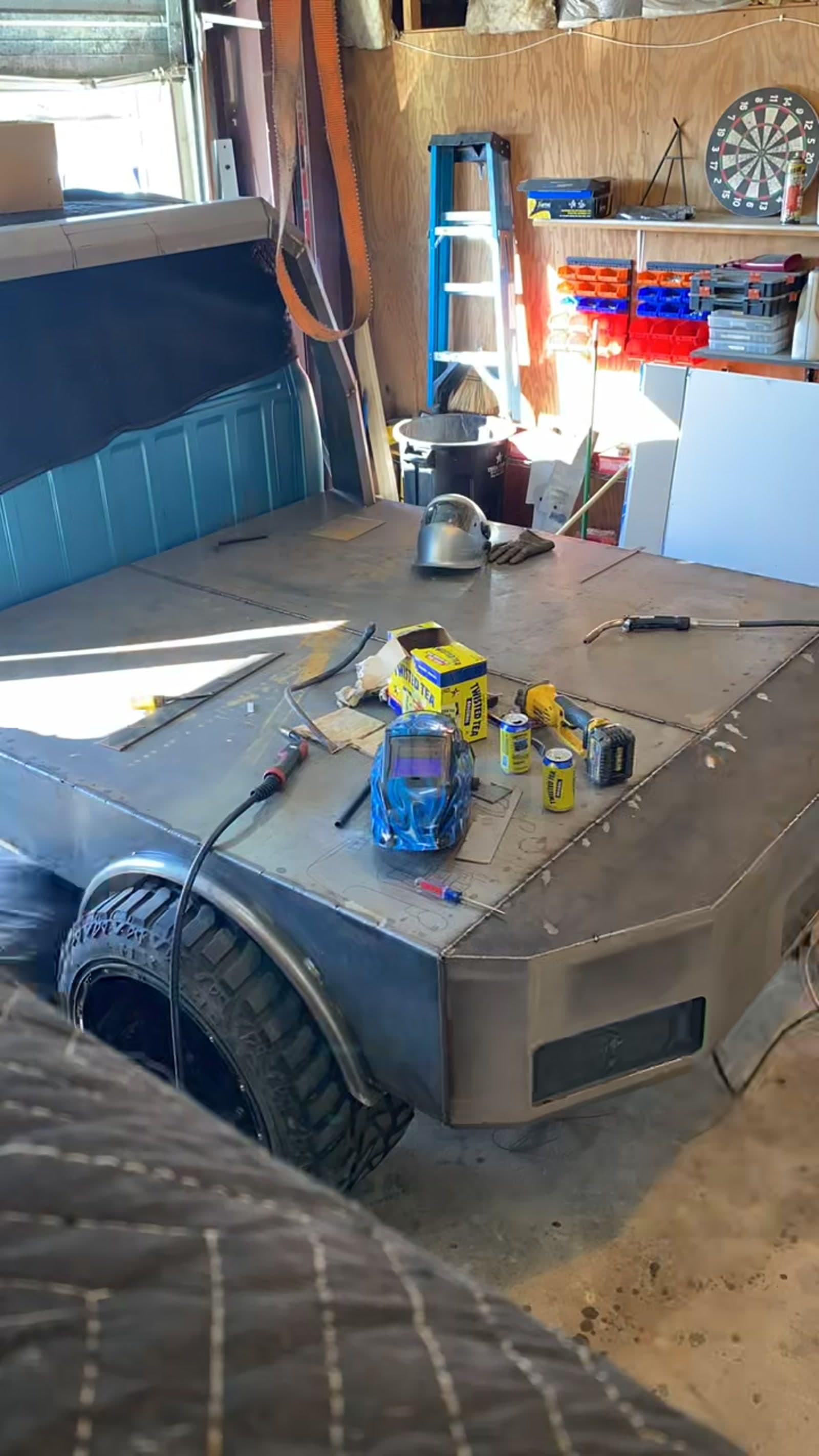 Custom steel flatbed under construction on the fabrication table at 2 Man Fab